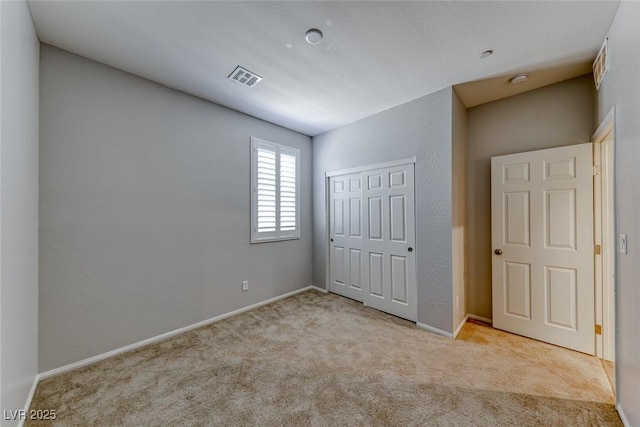 unfurnished bedroom with carpet flooring, a closet, and baseboards