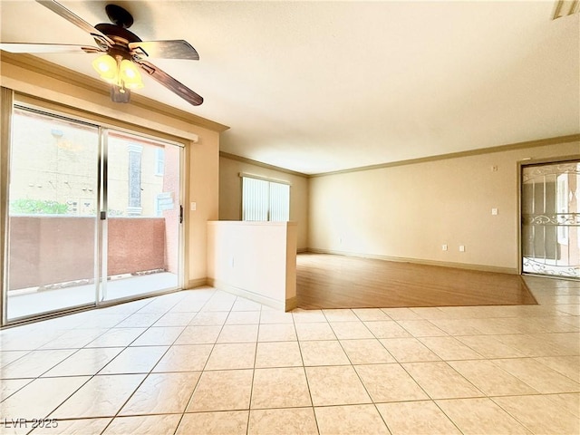 empty room with crown molding, a ceiling fan, baseboards, and light tile patterned floors