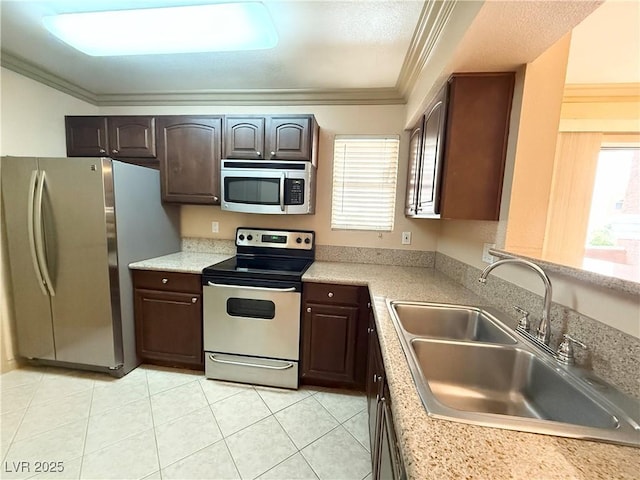 kitchen with light countertops, appliances with stainless steel finishes, and a sink