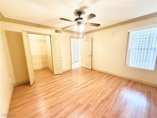 unfurnished bedroom featuring crown molding, baseboards, light wood-type flooring, visible vents, and a closet