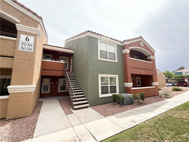 view of property featuring stairs and central AC