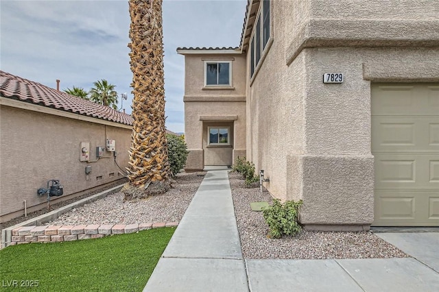 7829 Lovely Pine Pl, Las Vegas, NV 89143 - property entrance with a garage and stucco siding