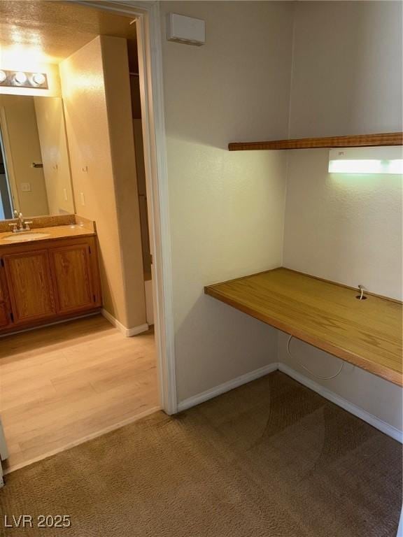 interior space featuring baseboards and vanity