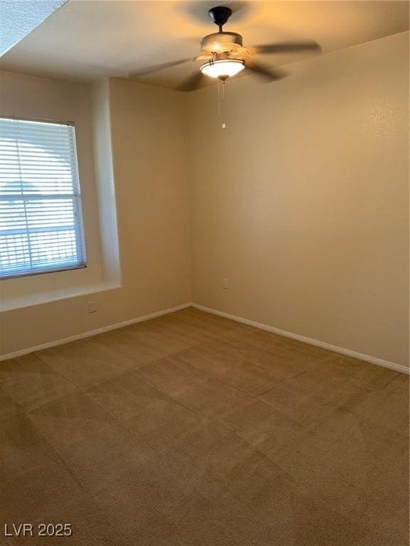 empty room with carpet floors, baseboards, and ceiling fan