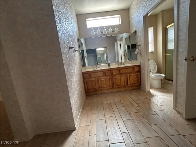 9048 Litchfield Ave, Las Vegas, NV 89134 - full bathroom featuring a sink, a stall shower, wood finish floors, and toilet