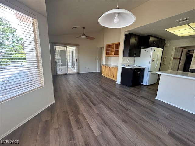 9048 Litchfield Ave, Las Vegas, NV 89134 - kitchen featuring visible vents, light countertops, baseboards, freestanding refrigerator, and dark cabinets