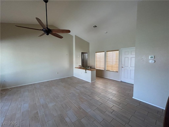 9048 Litchfield Ave, Las Vegas, NV 89134 - unfurnished living room featuring high vaulted ceiling, ceiling fan, baseboards, and wood finished floors