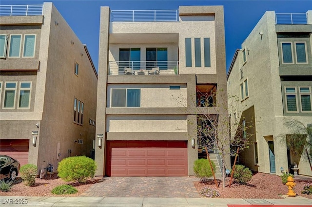 7953 Mountain Lilac St, Las Vegas, NV 89113 - view of front facade featuring decorative driveway, a garage, and stucco siding