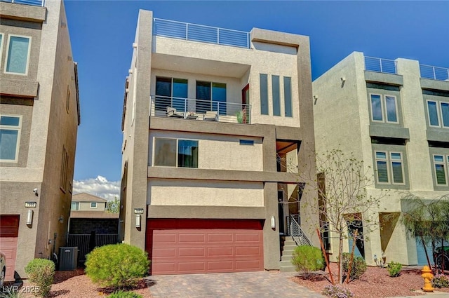 7953 Mountain Lilac St, Las Vegas, NV 89113 - view of front facade featuring central air condition unit, stucco siding, decorative driveway, and an attached garage