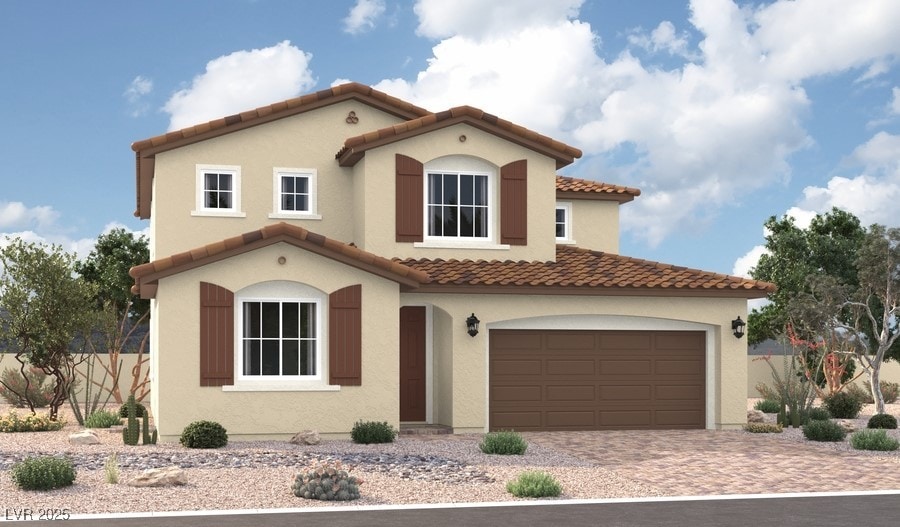 5712 E Badlands Ln, Pahrump, NV 89061 - mediterranean / spanish house featuring a tiled roof, a garage, driveway, and stucco siding