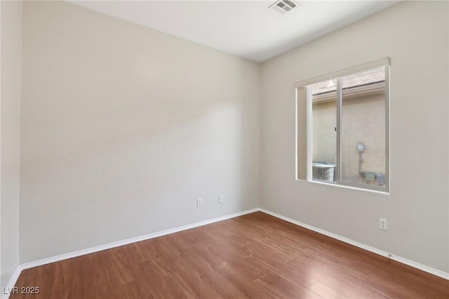 6059 Wheat Penny Ave, Las Vegas, NV 89122 - unfurnished room featuring wood finished floors, baseboards, and visible vents