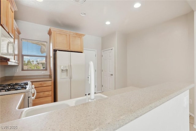 6059 Wheat Penny Ave, Las Vegas, NV 89122 - kitchen with recessed lighting, white appliances, light countertops, and light brown cabinetry
