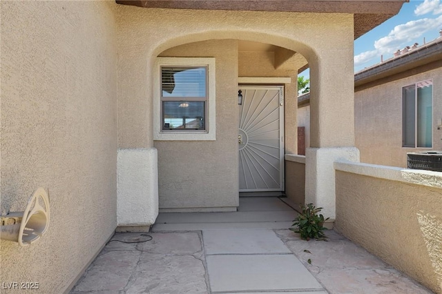 6059 Wheat Penny Ave, Las Vegas, NV 89122 - entrance to property featuring central air condition unit and stucco siding