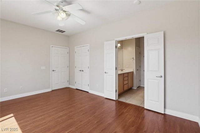 6059 Wheat Penny Ave, Las Vegas, NV 89122 - unfurnished bedroom featuring light wood finished floors, baseboards, and visible vents
