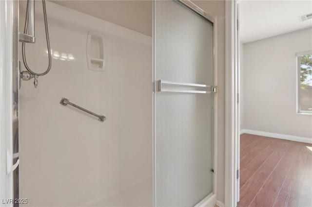 6059 Wheat Penny Ave, Las Vegas, NV 89122 - full bathroom with visible vents, baseboards, a stall shower, and wood finished floors