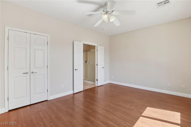 6059 Wheat Penny Ave, Las Vegas, NV 89122 - unfurnished bedroom featuring wood finished floors, baseboards, and visible vents