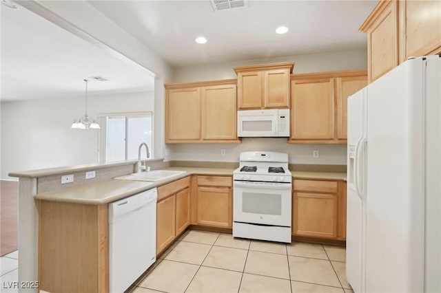 6059 Wheat Penny Ave, Las Vegas, NV 89122 - kitchen with white appliances, a peninsula, a sink, and light brown cabinetry