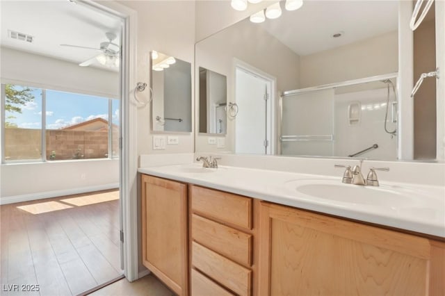 6059 Wheat Penny Ave, Las Vegas, NV 89122 - bathroom featuring a shower with door, visible vents, a sink, and wood finished floors