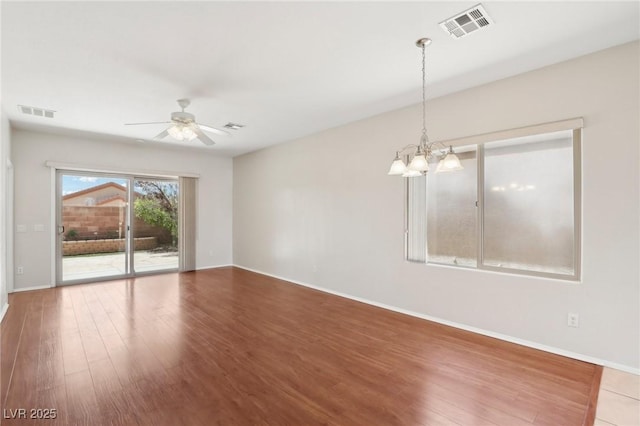 6059 Wheat Penny Ave, Las Vegas, NV 89122 - empty room featuring visible vents, wood finished floors, and ceiling fan with notable chandelier