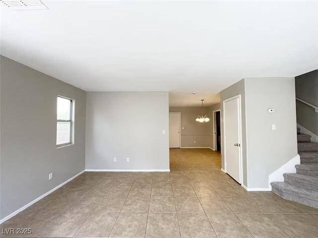 unfurnished living room featuring light tile patterned floors, visible vents, stairway, a notable chandelier, and baseboards