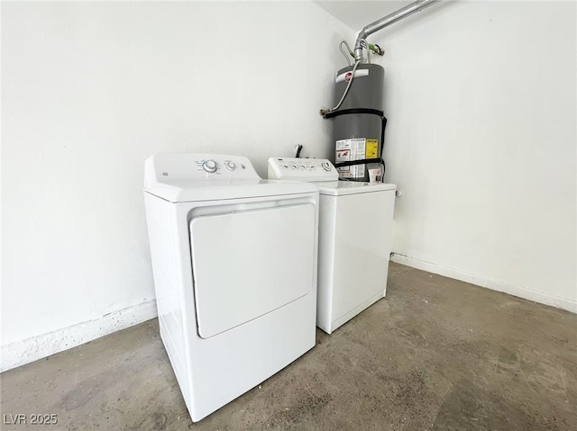 laundry area with washing machine and clothes dryer, strapped water heater, and laundry area