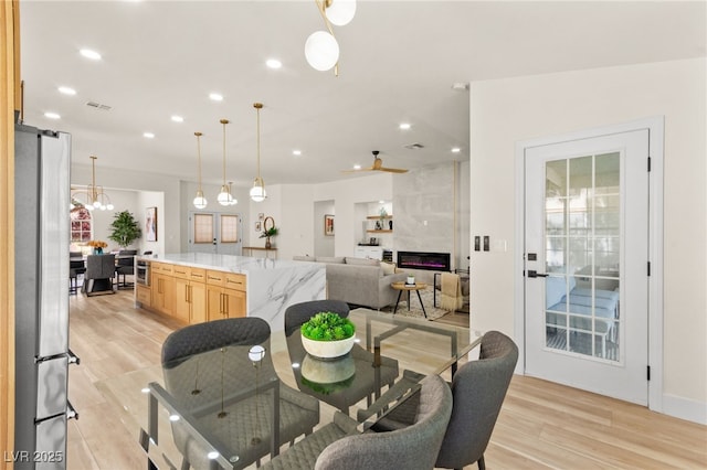 dining room featuring recessed lighting, light wood finished floors, and visible vents