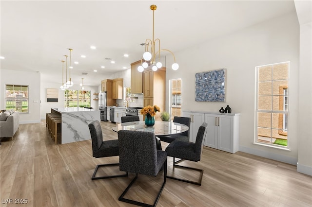 dining space featuring light wood-style flooring, baseboards, and recessed lighting