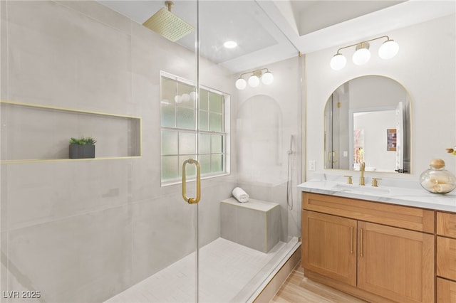 full bath with a shower stall, vanity, and wood finished floors