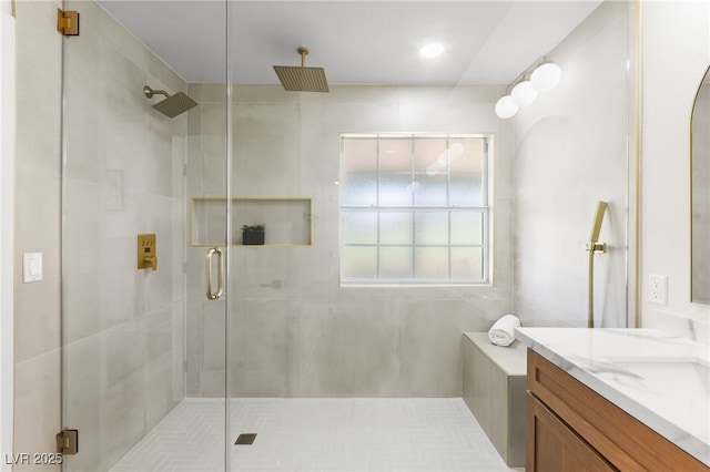 bathroom with a shower stall and vanity