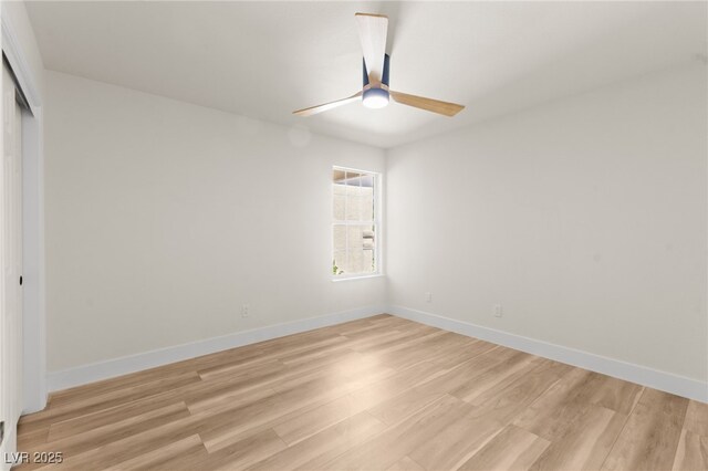 empty room with light wood-style floors, baseboards, and a ceiling fan