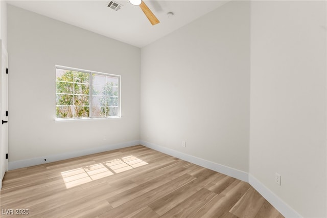 empty room featuring light wood-style floors, ceiling fan, baseboards, and visible vents