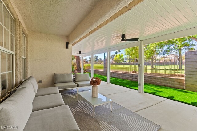 view of patio featuring outdoor lounge area, fence, and ceiling fan