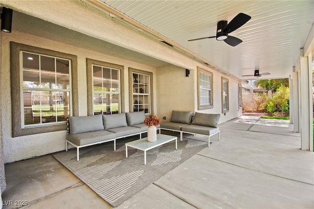 view of patio with an outdoor living space and a ceiling fan