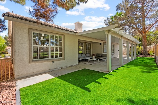 back of house with outdoor lounge area, a patio area, and stucco siding