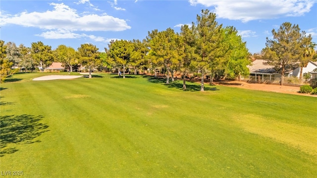 view of home's community with a yard and golf course view