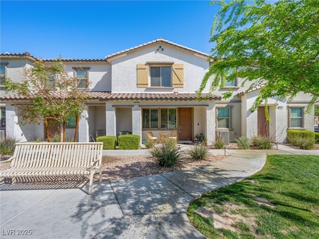 mediterranean / spanish-style home featuring a porch, stucco siding, and a tile roof