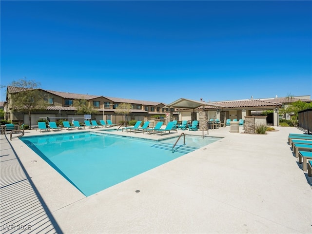 pool featuring a patio area and fence