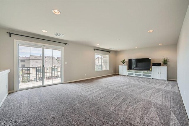 unfurnished living room featuring visible vents, baseboards, and carpet