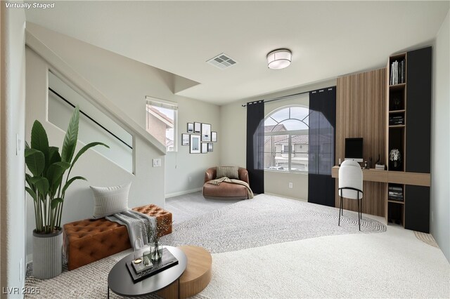 living area with carpet flooring, baseboards, and visible vents