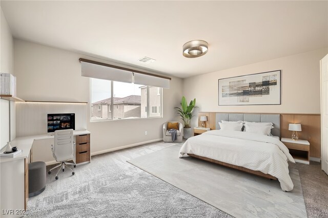 carpeted bedroom with visible vents and baseboards