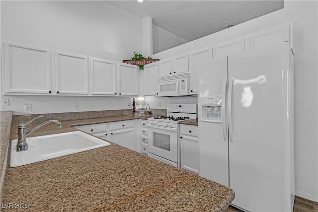 kitchen with white cabinets, a sink, and white appliances