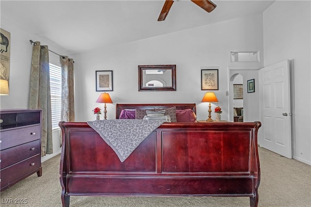 carpeted bedroom with lofted ceiling, a ceiling fan, and baseboards