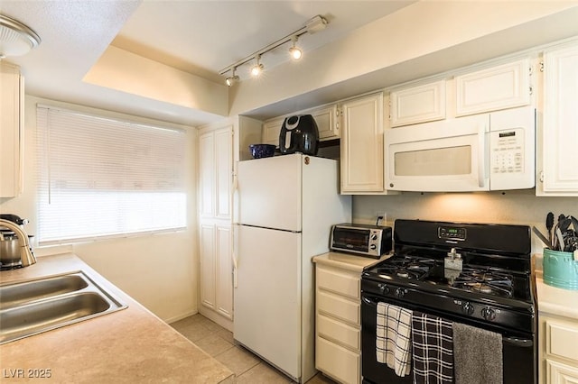 555 Rene Ln, Henderson, NV 89015 - kitchen with a toaster, white appliances, light countertops, light tile patterned flooring, and a sink