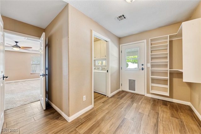 2681 Underbrush Ave, Pahrump, NV 89048 - foyer with washer / dryer, light wood-type flooring, visible vents, and baseboards
