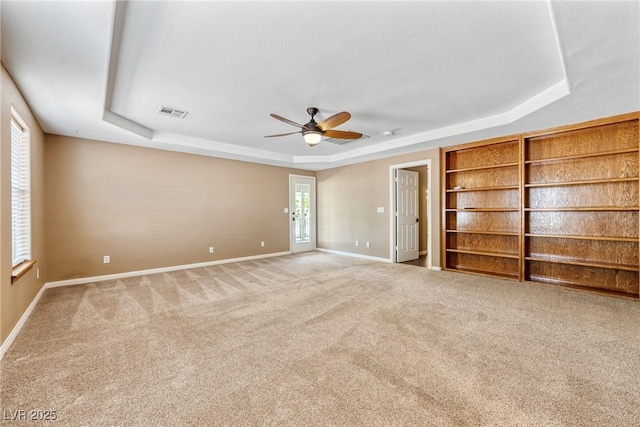 2681 Underbrush Ave, Pahrump, NV 89048 - empty room with a ceiling fan, a tray ceiling, baseboards, carpet flooring, and visible vents