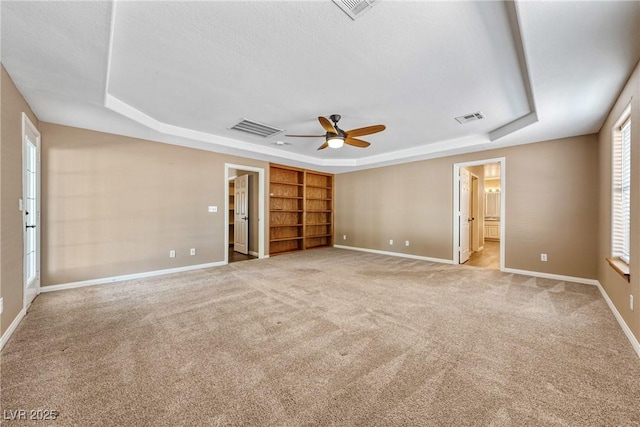 2681 Underbrush Ave, Pahrump, NV 89048 - unfurnished bedroom with a tray ceiling, visible vents, and light colored carpet