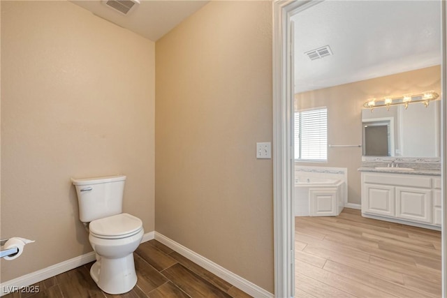 2681 Underbrush Ave, Pahrump, NV 89048 - bathroom with a bath, toilet, wood finished floors, and visible vents