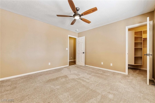 2681 Underbrush Ave, Pahrump, NV 89048 - unfurnished bedroom with baseboards, carpet flooring, a spacious closet, and ceiling fan