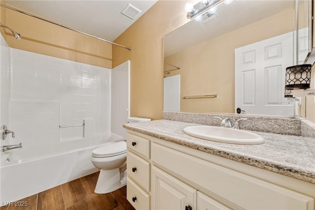 2681 Underbrush Ave, Pahrump, NV 89048 - full bath featuring wood finished floors, visible vents, toilet, vanity, and shower / tub combination