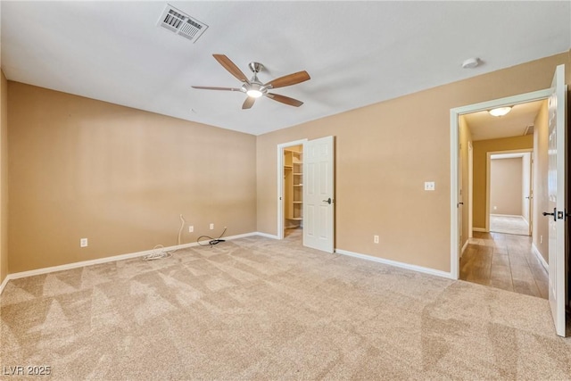 2681 Underbrush Ave, Pahrump, NV 89048 - unfurnished bedroom with a spacious closet, visible vents, light carpet, baseboards, and ceiling fan